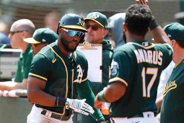 Starling Marte of the Oakland Athletics celebrates after scoring on a single by Mitch Moreland in the bottom of the first inning against the Seattle...