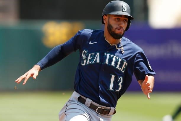 Base runner Abraham Toro of the Seattle Mariners rounds the bases to score against the Oakland Athletics at RingCentral Coliseum on August 24, 2021...
