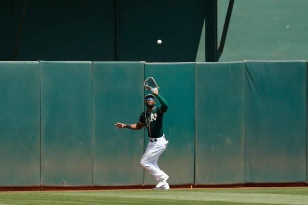 Starling Marte of the Oakland Athletics catches a fly ball against the Seattle Mariners at RingCentral Coliseum on August 24, 2021 in Oakland,...