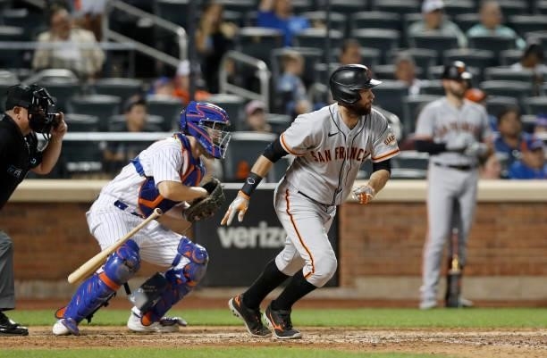 Brandon Belt of the San Francisco Giants follows through on an eighth inning RBI infield single against the New York Mets at Citi Field on August 24,...