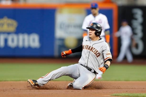 Wilmer Flores of the San Francisco Giants slides into second base on his double in the second inning against the New York Mets at Citi Field on...
