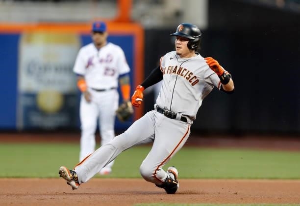 Wilmer Flores of the San Francisco Giants slides into second base on his double in the second inning against the New York Mets at Citi Field on...
