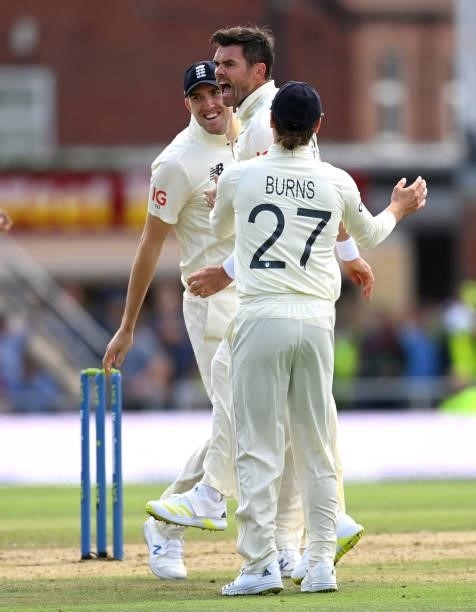 James Anderson of England celebrates with Craig Overton and Rory Burns after dismissing Virat Kohli of India during day one of the Third LV=...