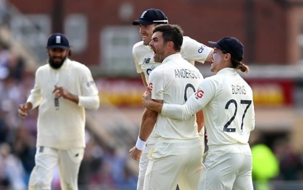 James Anderson of England celebrates with Craig Overton and Rory Burns after dismissing Virat Kohli of India during day one of the Third LV=...