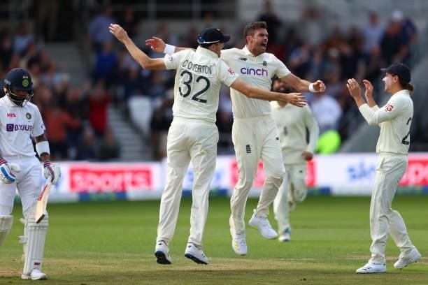 James Anderson of England celebrates with Craig Overton and Rory Burns taking the wicket of Virat Kohli of India at Emerald Headingley Stadium on...