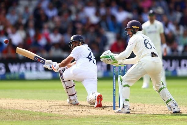 Rohit Sharma of India sweeps a delivery off Moeen Ali as England wicketkeeper Jos Buttler looks on at Emerald Headingley Stadium on August 25, 2021...
