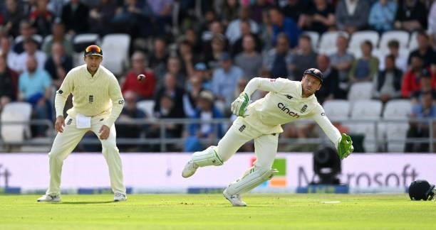 England wicketkeeper Jos Buttler dives for the ball watched by England captain Joe Root during day one of the Third LV= Insurance Test Match between...