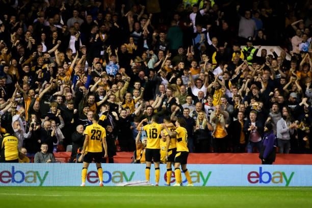 Romain Saiss of Wolverhampton Wanderers celebrates scoring his team's first goal with teammates during the Carabao Cup Second Round match between...