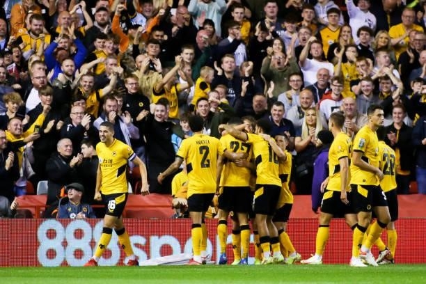 Romain Saiss of Wolverhampton Wanderers celebrates scoring his team's first goal with teammates during the Carabao Cup Second Round match between...