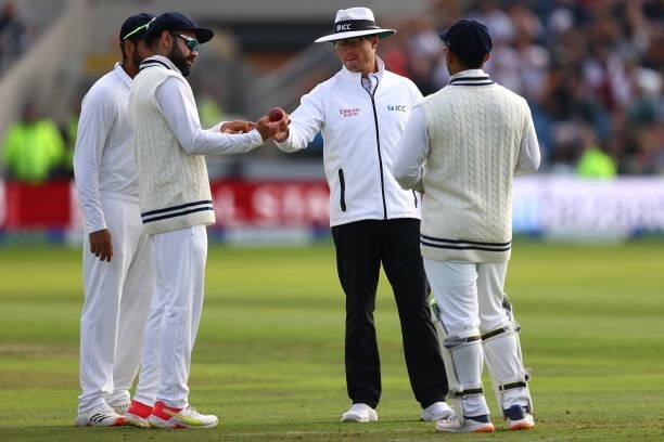 Umpire Alex Wharf shows India captain Virat Kohli the change of ball during day one of the Third Test Match between England and India at Emerald...