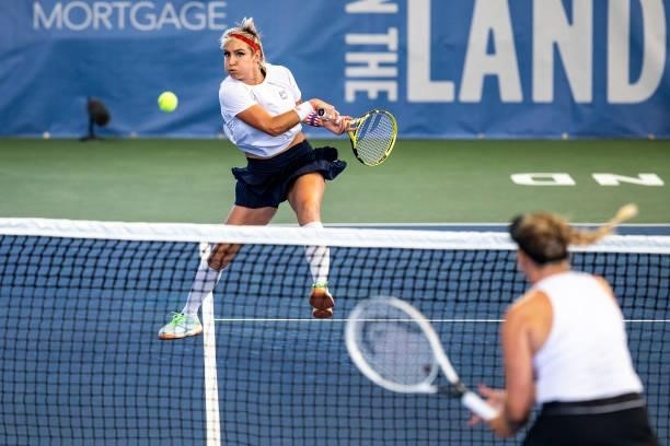 Bethanie Mattek-Sands of USA volleys the ball to Julia Lohoff of Germany and Renata Voráová of Czechia during the first set of their match on day 3...