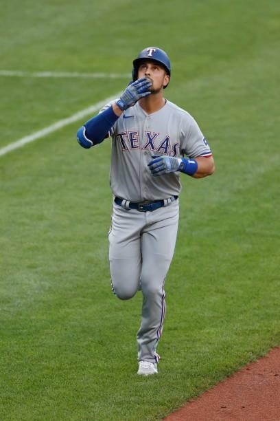 Nathaniel Lowe of the Texas Rangers rounds the bases after hitting a three run home run off Eli Morgan of the Cleveland Indians during the first...