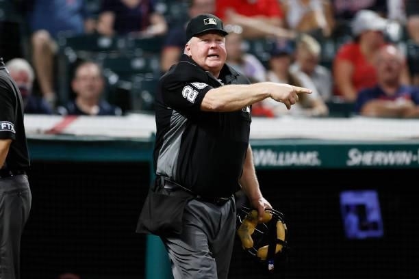 Umpire Bill Miller makes a call after a review during the fifth inning of the game between the Texas Rangers and the Cleveland Indians at Progressive...