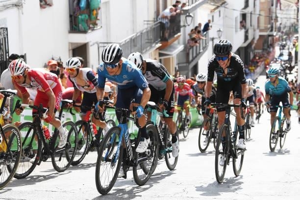 Michael Matthews of Australia and Team BikeExchange and Romain Bardet of France and Team DSM passing through Valdepeñas de Jaén Village while fans...