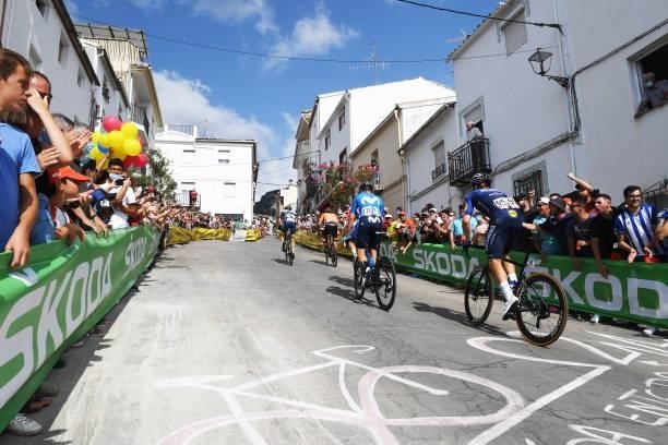 Florian Senechal of France and Team Deceuninck - Quick-Step and The Peloton passing through Valdepeñas de Jaén Village while fans cheer during the...