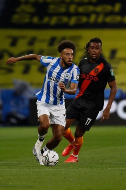 Sorba Thomas of Huddersfield Town races away from Alex Iwobi of Everton during the game between Huddersfield Town and Everton in the second round of...