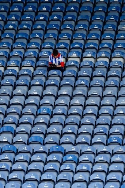 Huddersfield Town fan reads the match day programme before the Carabao Cup Second Round match between Huddersfield Town and Everton at John Smiths...