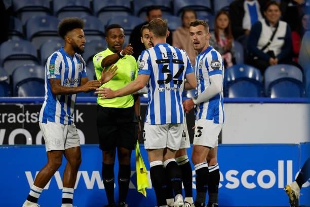 Assistant referee Akil Howson explains the offside decision that disallowed a Town goal during the game between Huddersfield Town and Everton in the...