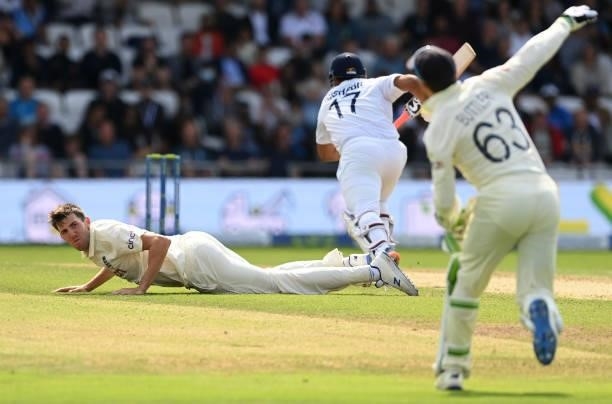 Craig Overton of England lies on the ground as Jos Buttler attempts to run out Rishabh Pant of India during the first day of the 3rd LV= Test Match...