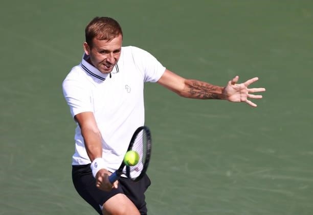 Daniel Evans of Great Britain returns a shot to Richard Gasquet of France on Day 5 of the Winston-Salem Open at Wake Forest Tennis Complex on August...