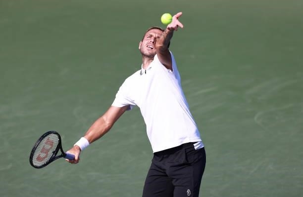 Daniel Evans of Great Britain serves to Richard Gasquet of France on Day 5 of the Winston-Salem Open at Wake Forest Tennis Complex on August 25, 2021...