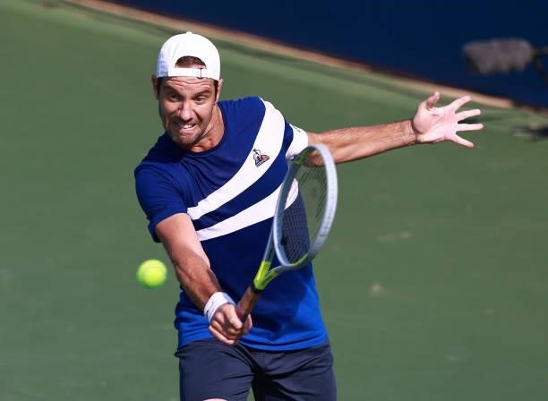 Richard Gasquet of France returns a shot to Daniel Evans of Great Britain on Day 5 of the Winston-Salem Open at Wake Forest Tennis Complex on August...