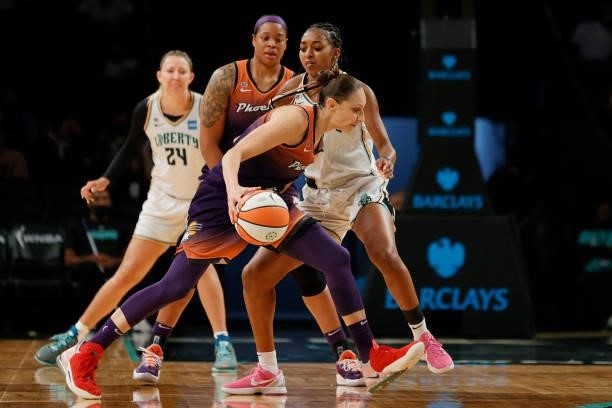 Diana Taurasi of the Phoenix Mercury dribbles as DiDi Richards of the New York Liberty defends during the first half at Barclays Center on August 25,...