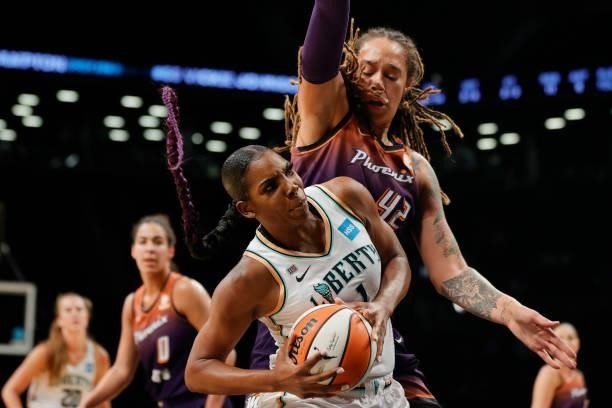 Reshanda Gray of the New York Liberty drives to the basket as Brittney Griner of the Phoenix Mercury defends during the first half at Barclays Center...