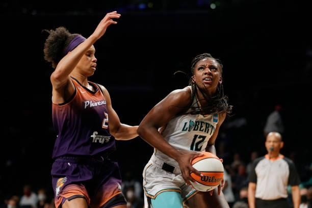 Michaela Onyenwere of the New York Liberty dribbles the ball as Brianna Turner of the Phoenix Mercury defends during the first half at Barclays...