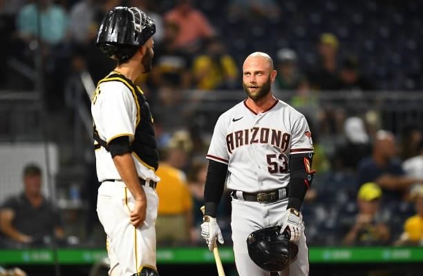 Christian Walker of the Arizona Diamondbacks talks with Jacob Stallings of the Pittsburgh Pirates at PNC Park on August 23, 2021 in Pittsburgh,...