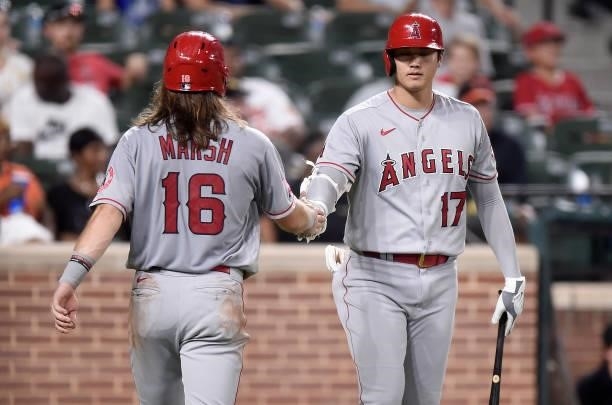 Brandon Marsh of the Los Angeles Angels celebrates with Shohei Ohtani after scoring in the fourth inning against the Baltimore Orioles at Oriole Park...