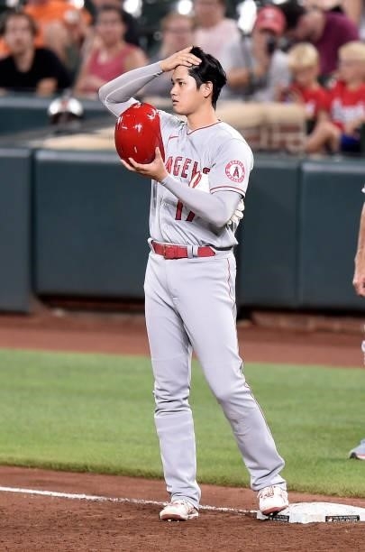 Shohei Ohtani of the Los Angeles Angels stands on first base in the sixth inning against the Baltimore Orioles at Oriole Park at Camden Yards on...