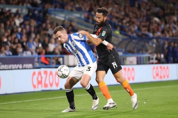 Harry Toffolo of Huddersfield Town shields the ball from Andros Townsend of Everton during the Carabao Cup Second Round match between Huddersfield...