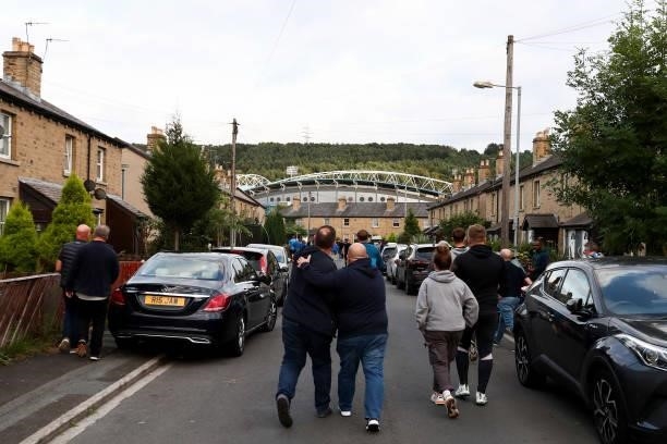 Fans greet as they walk to the stadium prior to the Carabao Cup Second Round match between Huddersfield Town and Everton at The John Smith's Stadium...
