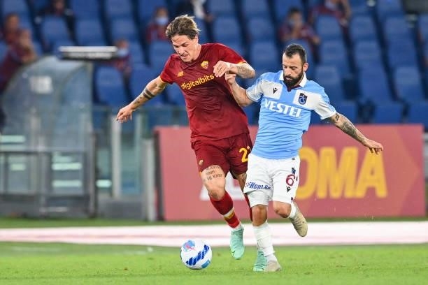 Nicolò Zaniolo of AS Roma fights for the ball with Manolis Siopis of Trabzonspor during the UEFA Conference League Play-Offs Leg Two match between AS...