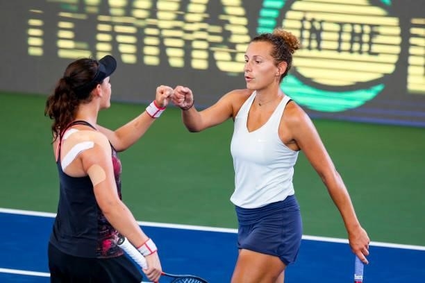 Elixane Lechemia of France fist bumps Ingrid Neel of USA during the second set of their doubles match against Ulrikke Eikeri of Norway and Catherine...