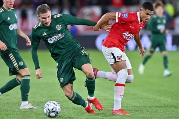 Carl Starfelt of Celtic, Jesper Karlsson of AZ during the UEFA Europa League play off match between AZ and Celtic at AFAS Stadion on August 26, 2021...
