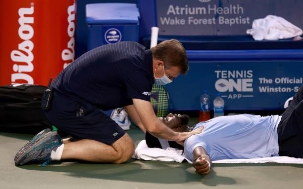 Trainer tends to Frances Tiafoe during his match against Mikael Ymer of Sweden in the quarterfinals of the Winston-Salem Open at Wake Forest Tennis...