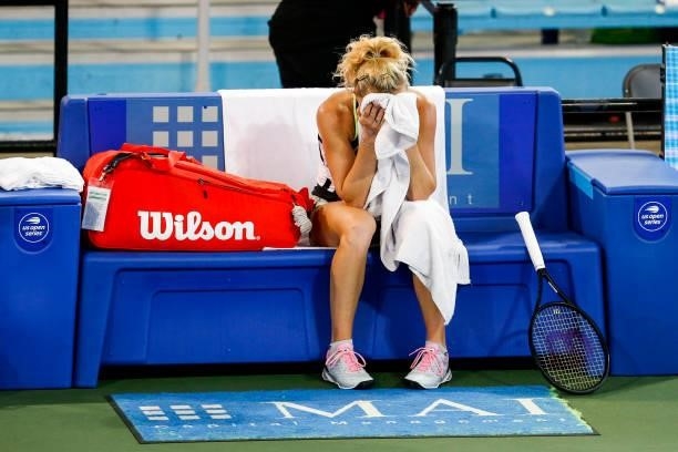 Katerina Siniakova of the Czech Republic wipes off her face during a break in the second set of her quarterfinal match against Anett Kontaveit of...