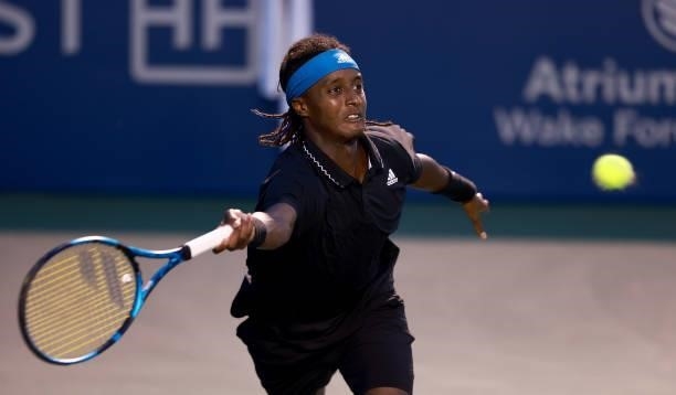 Mikael Ymer of Sweden returns a shot to Frances Tiafoe in the quarterfinals of the Winston-Salem Open at Wake Forest Tennis Complex on August 26,...
