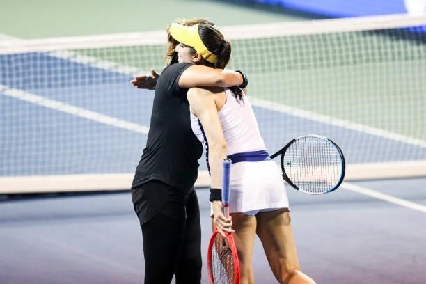 Sania Mirza of India and Christina McHale of USA hug after winning their quarterfinal doubles match against Shuai Zhang of China and Lucie Hradecká...