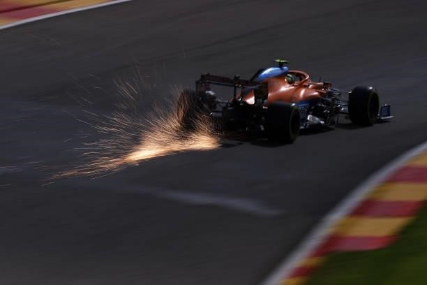 Sparks fly behind Lando Norris of Great Britain driving the McLaren F1 Team MCL35M Mercedes during practice ahead of the F1 Grand Prix of Belgium at...