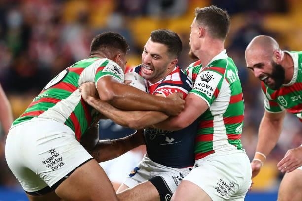 James Tedesco of the Roosters is tackled during the round 24 NRL match between the Sydney Roosters and the South Sydney Rabbitohs at Suncorp Stadium...