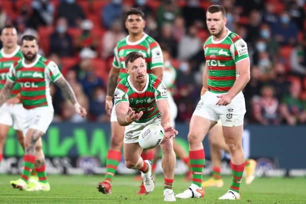 Damien Cook of the Rabbitohs offloads the ball during the round 24 NRL match between the Sydney Roosters and the South Sydney Rabbitohs at Suncorp...