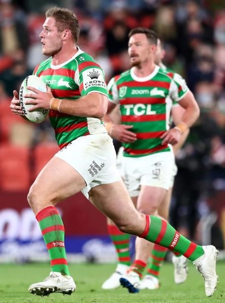 Thomas Burgess of the Rabbitohs runs the ball during the round 24 NRL match between the Sydney Roosters and the South Sydney Rabbitohs at Suncorp...