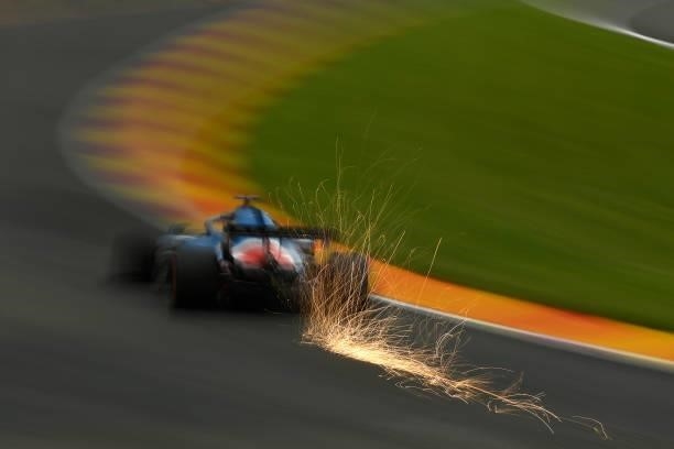 Sparks fly behind Fernando Alonso of Spain driving the Alpine A521 Renault during practice ahead of the F1 Grand Prix of Belgium at Circuit de...