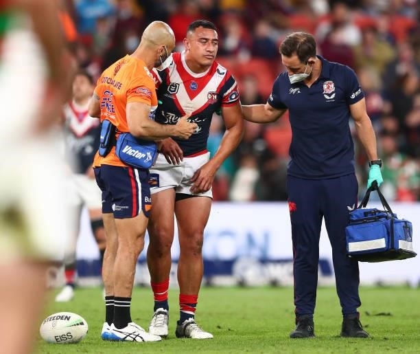 Siosiua Taukeiaho of the Roosters is attended to by team trainers after an injury during the round 24 NRL match between the Sydney Roosters and the...