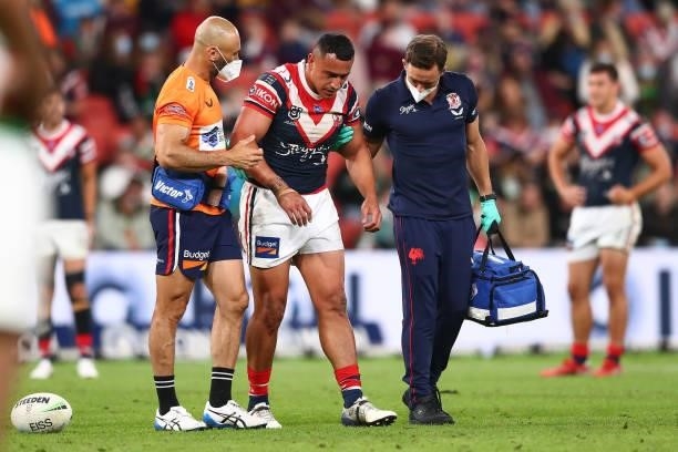 Siosiua Taukeiaho of the Roosters is attended to by team trainers after an injury during the round 24 NRL match between the Sydney Roosters and the...