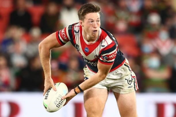 Sam Verrills of the Roosters offloads the ball during the round 24 NRL match between the Sydney Roosters and the South Sydney Rabbitohs at Suncorp...