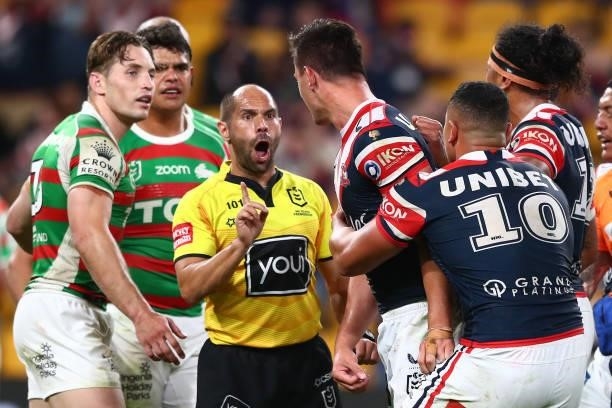 Referee Ashley Klein speaks with Joseph Manu of the Roosters after receiving a high tackle from Latrell Mitchell of the Rabbitohs during the round 24...